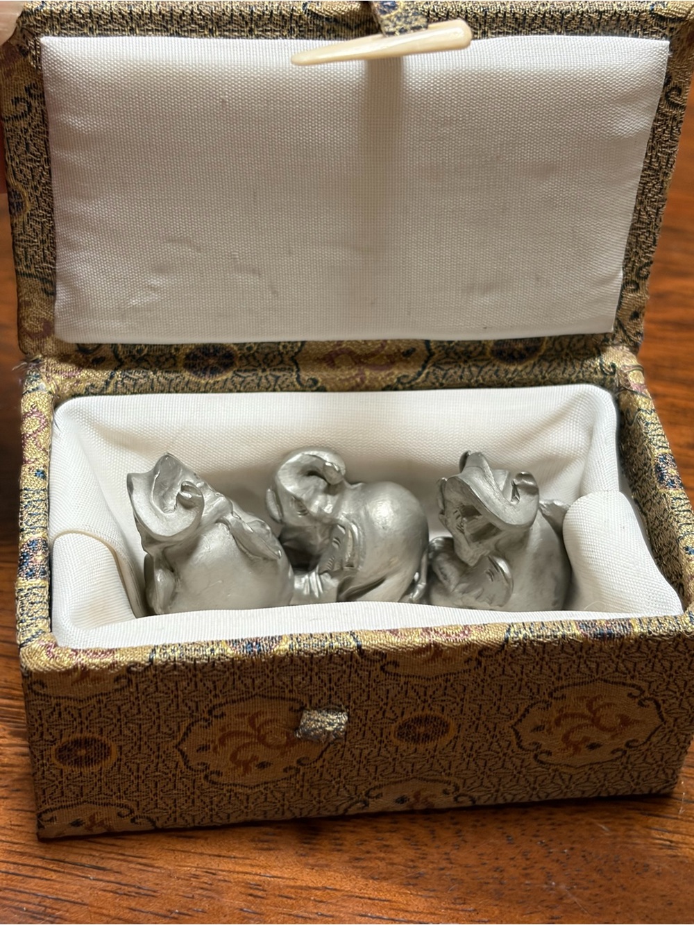 Lot of 3 miniature elephant figurines resemble silver collectibles.